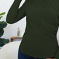 Woman wearing FAM-FAM Army Green Ruched Mock Neck Long Sleeve T-Shirt, perfect for fall fashion and cozy layering.