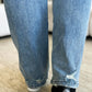 Close-up of back view of person wearing High Waist Distressed Straight Jeans by Judy Blue Jeans showing distressed detailing.