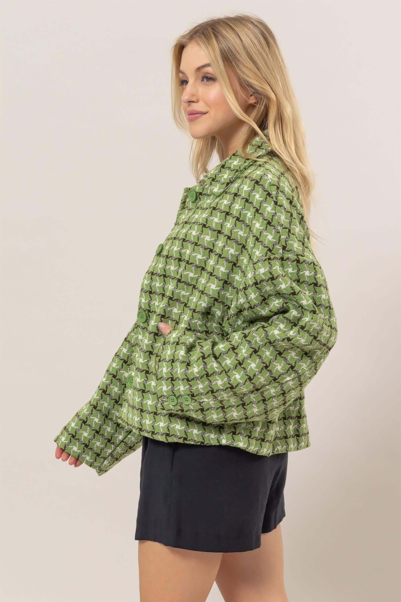 Stylish woman in green tweed plaid button-up jacket, showcasing a modern collared neck and relaxed fit.