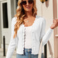 Woman wearing Bella Road Button Up Long Sleeve Cardigan in white with sunglasses and handbag.