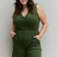 Plus-size model wearing Forever Yours V-Neck Sleeveless Romper in Army Green with pockets for casual outdoor activities.