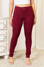 Woman wearing red skinny jeans with pockets from YMI Jeans, showcasing a flattering and comfortable fit with slightly stretchy fabric.