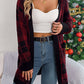 Woman wearing Bella Road Plaid Open Front Long Sleeve Cardigan by a Christmas tree, stylish winter fashion look.