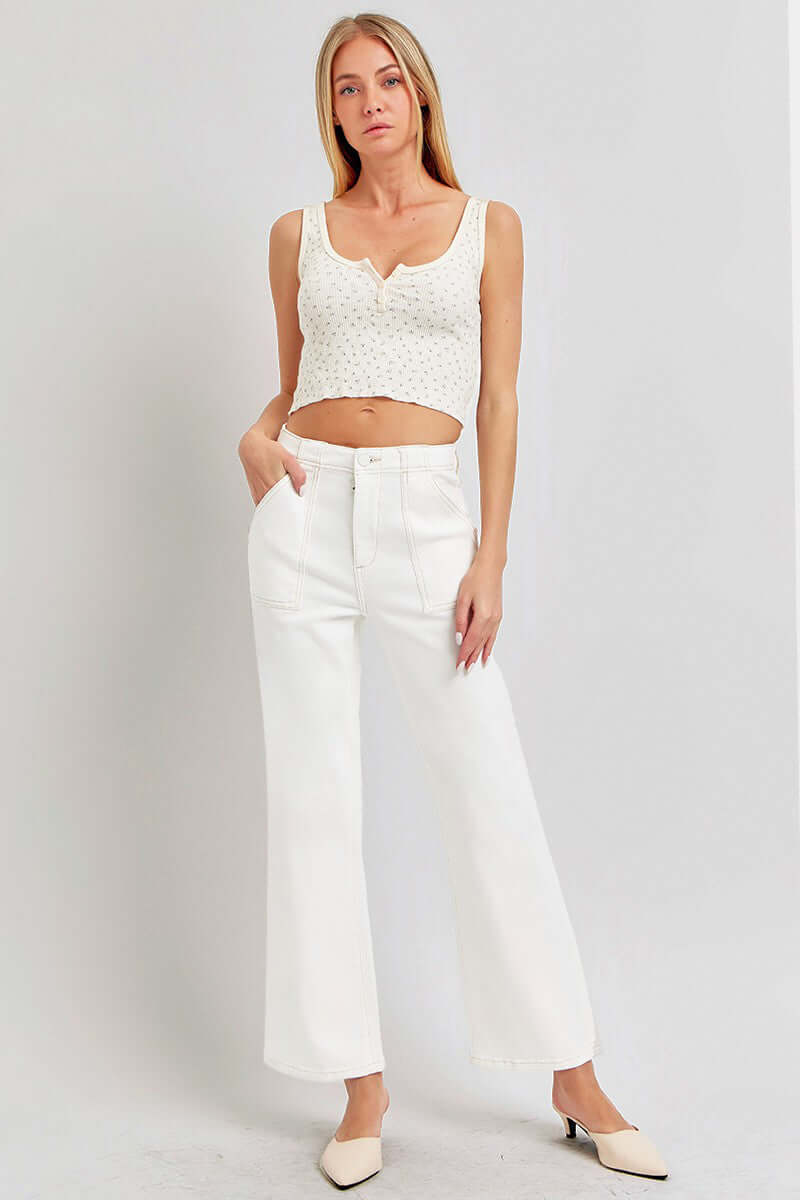 White high-rise ankle flare jeans with patch pockets, styled with a crochet crop top, showcasing a chic and casual look.