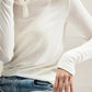 Woman wearing Basic Bae Notched Long Sleeve T-Shirt with jeans, showcasing stylish notched neckline and comfy long sleeves