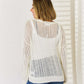 Woman wearing Openwork Ribbed Trim Long Sleeve Knit Top in white, showcasing back details and openwork design.