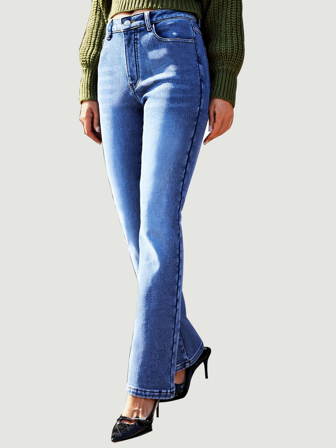 Woman wearing Bella Road Straight Leg Jeans with pockets, paired with a green sweater and black high heels.