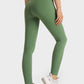 Model showcasing Millennia Ultra Soft High Waist Leggings in green from the side, perfect for yoga and athleisure wear.