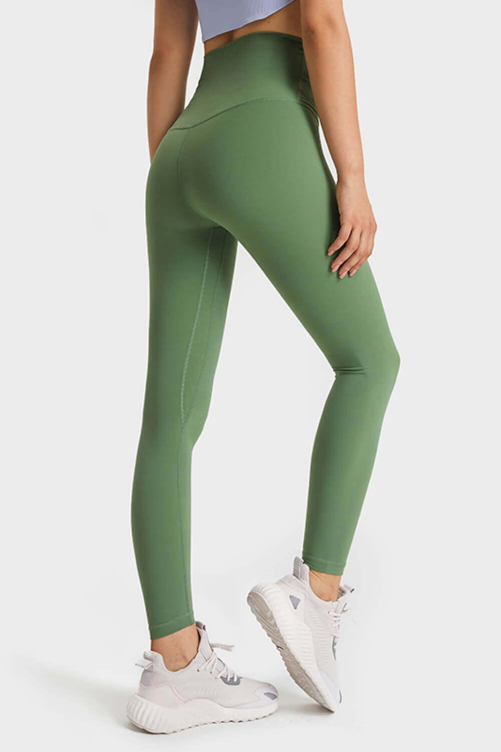 Model showcasing Millennia Ultra Soft High Waist Leggings in green from the side, perfect for yoga and athleisure wear.