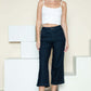 Woman wearing Judy Blue crop wide leg jeans with side seam braid detail and white top.