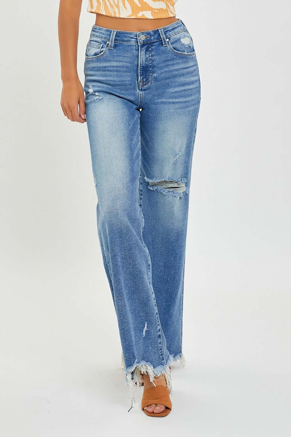 Stylish High Rise Frayed Hem Wide Leg Risen Jeans in blue denim, perfect for a chic and vintage inspired outfit.