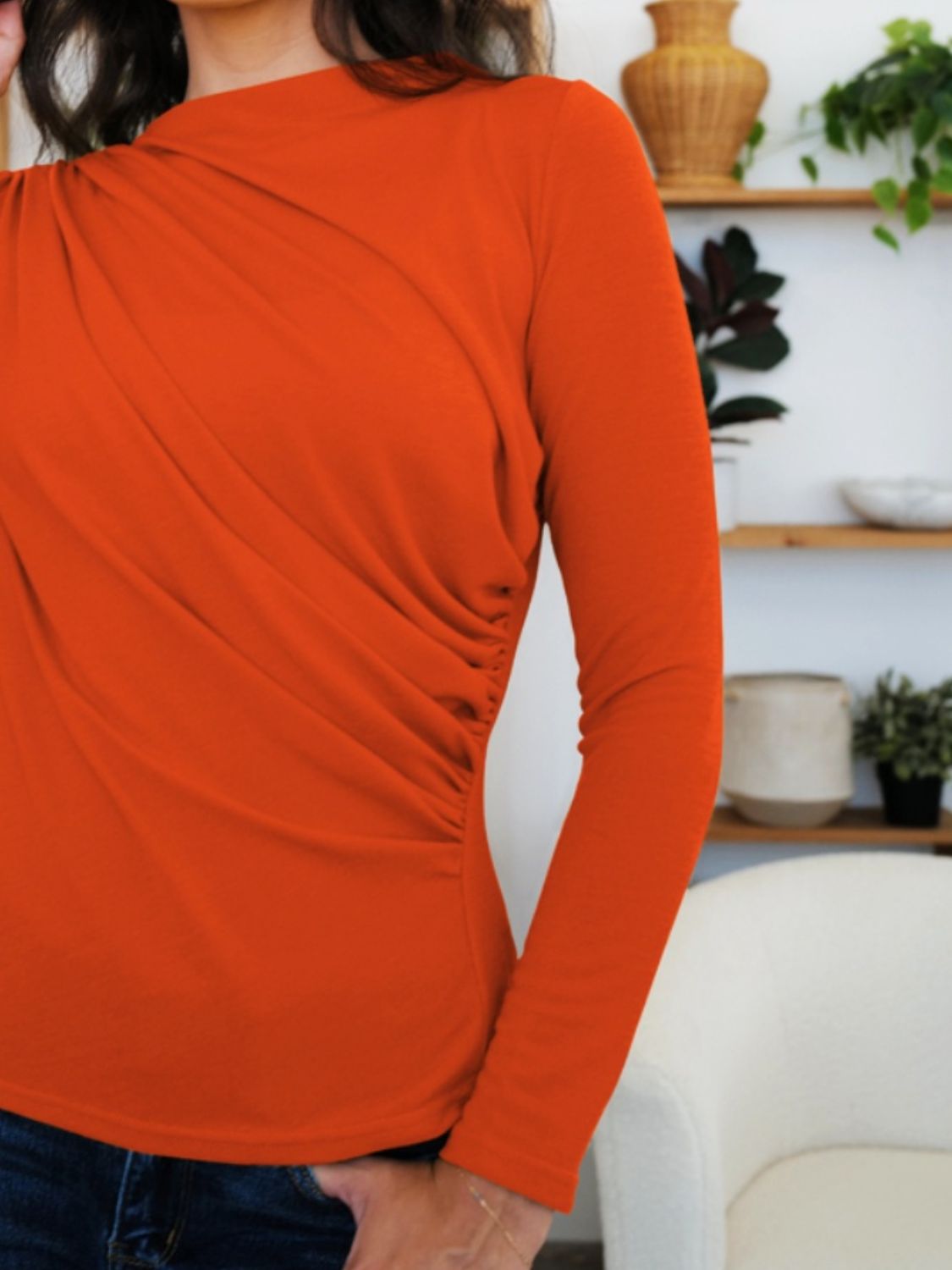 Woman wearing FAM-FAM Ruched Mock Neck Long Sleeve T-Shirt in vibrant orange, showcasing unique style ideal for fall fashion.