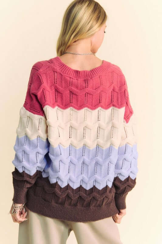 Back view of Davi & Dani Wavy Texture Color Block V-Neck Sweater in pink, cream, lavender, and brown hues, stylish and cozy for fall.