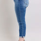 Judy Blue plus size button fly distressed jeans, showcasing stylish pockets and a flattering fit, perfect for casual wear.