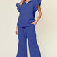 Woman wearing a blue Texture Ruffle Short Sleeve Top and Drawstring Wide Leg Pants Set, featuring pockets and slightly stretchy material.