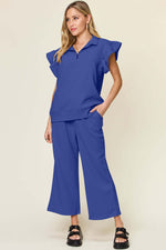 Woman wearing a blue Texture Ruffle Short Sleeve Top and Drawstring Wide Leg Pants Set, featuring pockets and slightly stretchy material.