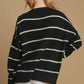 Stylish black and white striped wool blend sweater with round neck, perfect for layering in cooler weather.