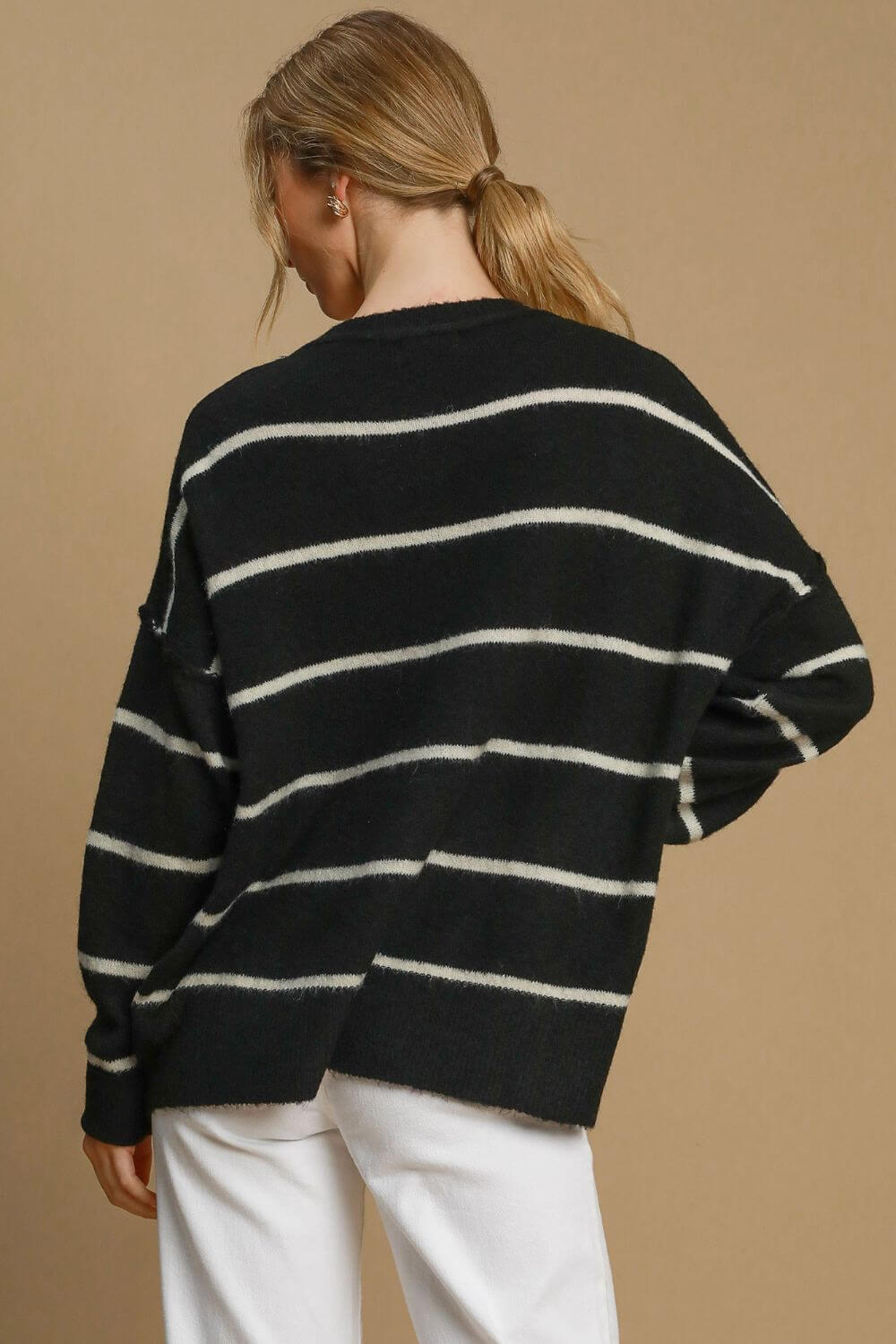 Stylish black and white striped wool blend sweater with round neck, perfect for layering in cooler weather.