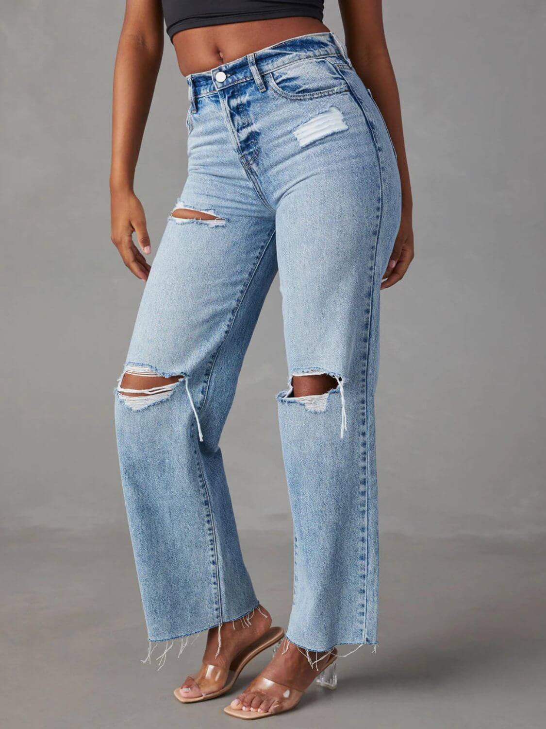 Woman wearing Bella Road distressed straight leg jeans with pockets, featuring ripped details on blue denim, no stretch, casual fit.