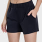 Millennia elastic waist active shorts in black with pockets and stretch fabric for comfort and movement.