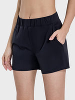 Millennia elastic waist active shorts in black with pockets and stretch fabric for comfort and movement.