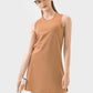 Millennia Round Neck Sleeveless Active Dress in caramel, perfect for workouts and sports, with stylish visor and tennis racket.