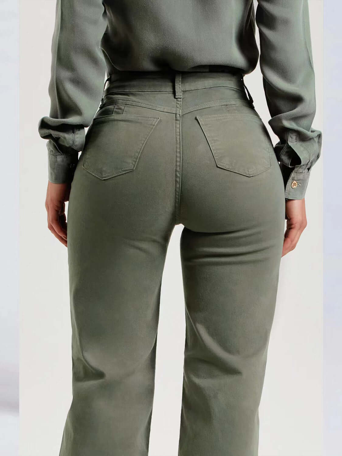 Back view of Buttoned Raw Hem Jeans with Pockets in green, showcasing slightly stretchy fit and comfortable design.