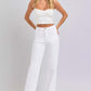 Woman wearing high waist straight white Risen Jeans, showcasing a flattering silhouette and contemporary comfort.