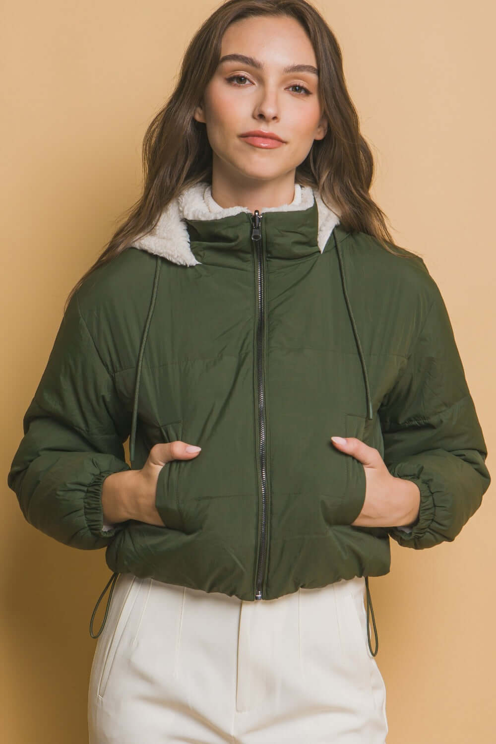 Woman wearing Love Tree Zip Up Cropped Hooded Sherpa Reversible Jacket in stylish green, perfect for cozy and versatile fashion.