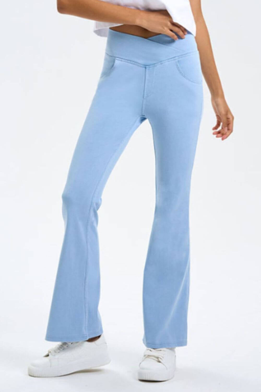 Light blue bootcut jeans with pockets, featuring a stretchy fit and stylish design for ultimate comfort and versatility.