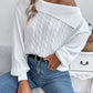 Woman wearing Bella Road Cable-Knit One Shoulder Long Sleeve Sweater in white, paired with blue jeans, showcasing the cozy and stylish design.