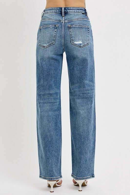 Back view of RISEN full size distressed wide leg jeans in a relaxed fit with stylish detailing.