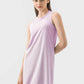 Model wearing a sleeveless purple Millennia active dress, showcasing its comfortable and stylish design for workouts.