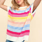 Woman wearing a Striped Side Slit Short Sleeve Knit Top in vibrant colors paired with denim shorts.