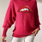 Bella Road Lip Turtleneck Sweater in red, featuring bold lip design, stylish and playful winter fashion with moderate stretch.