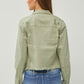 Back view of a trendy cropped denim jacket with raw hem, paired with stylish jeans, showcasing modern fashion.