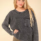 Woman wearing Very J Mineral Washed Exposed Seam Sweater with drop shoulder, round neck, long sleeves, patch pocket, and rolled hem.