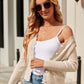 Woman wearing Bella Road Button Up Long Sleeve Cardigan over white top, paired with jeans and sunglasses, standing outdoors.