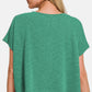 Woman wearing a green V-neck short sleeve t-shirt with jeans, view from the back.