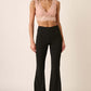 Stylish woman wearing Mittoshop Crepe Knit Elastic Waist Flare Leg Pants with a chic top, showcasing versatile fashion.