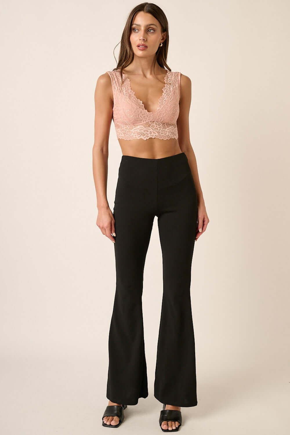 Stylish woman wearing Mittoshop Crepe Knit Elastic Waist Flare Leg Pants with a chic top, showcasing versatile fashion.