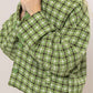 Stylish green plaid button-up jacket featuring a collared neck and cozy design, perfect for layering and trendy looks.