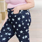 Woman wearing Janelle full size high waist star print flare jeans by Judy Blue Jeans, showcasing dark wash and flattering fit.