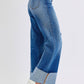 Side view of Judy Blue distressed high waist wide leg jeans showcasing a fashionable silhouette and trendy raw hem.