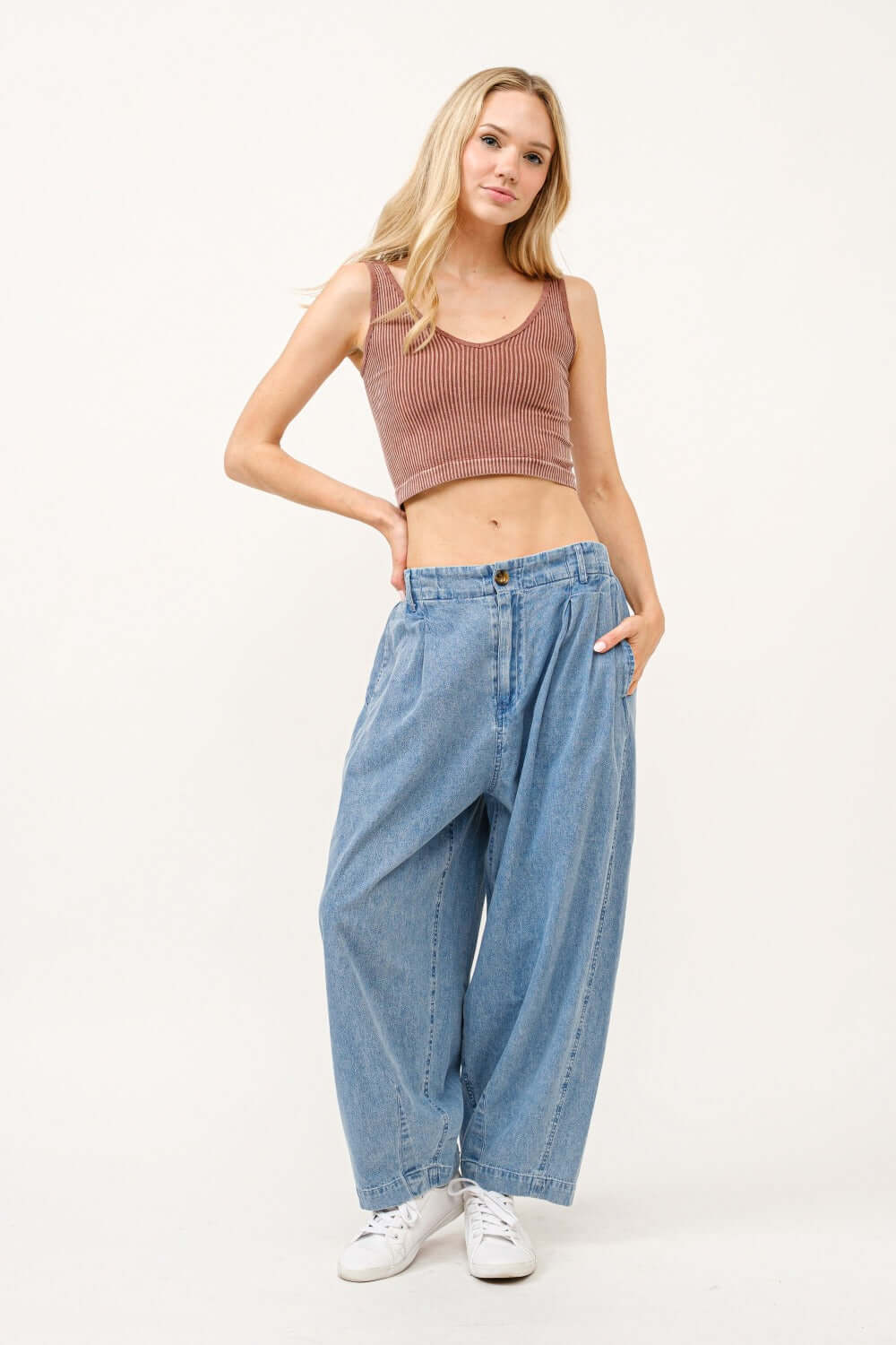 Woman wearing elastic back pleated baggy jeans with comfortable waistband and pockets, showcasing relaxed denim style.