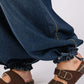 Mid-rise cargo jeans with cinch-tie banded ankles paired with brown sandals