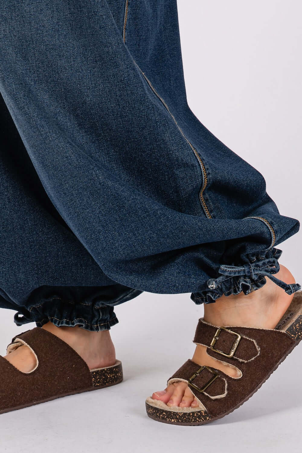 Mid-rise cargo jeans with cinch-tie banded ankles paired with brown sandals