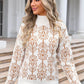 Woman wearing Angel Wings Flower Turtleneck Sweater with floral design, standing stylishly outside a building.