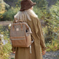 Woman wearing Himawari water-resistant canvas backpack with side pockets on a nature trail.