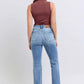 Back view of a model wearing Judy Blue high rise bootcut jeans with raw hem and a fitted top, showcasing a trendy outfit.